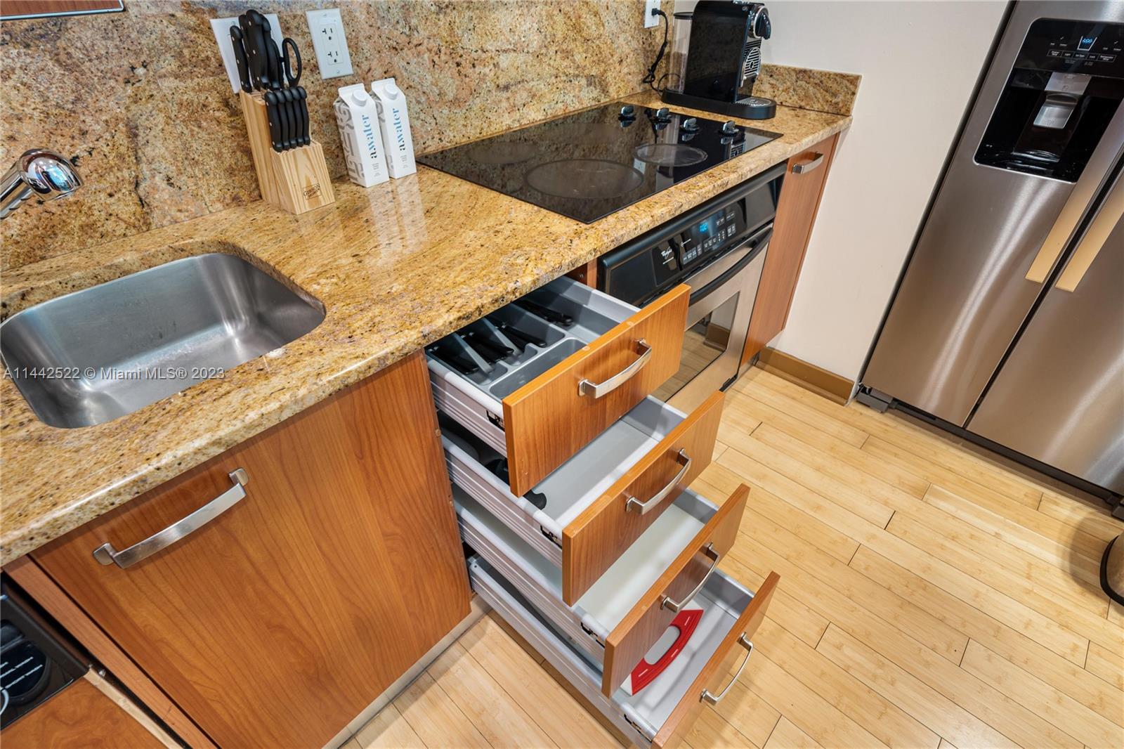 1395 Brickell Avenue, Unit 3205 Miami, FL 33131 - Photo 4 of 18 a kitchen with a sink a stove top oven and a counter top space