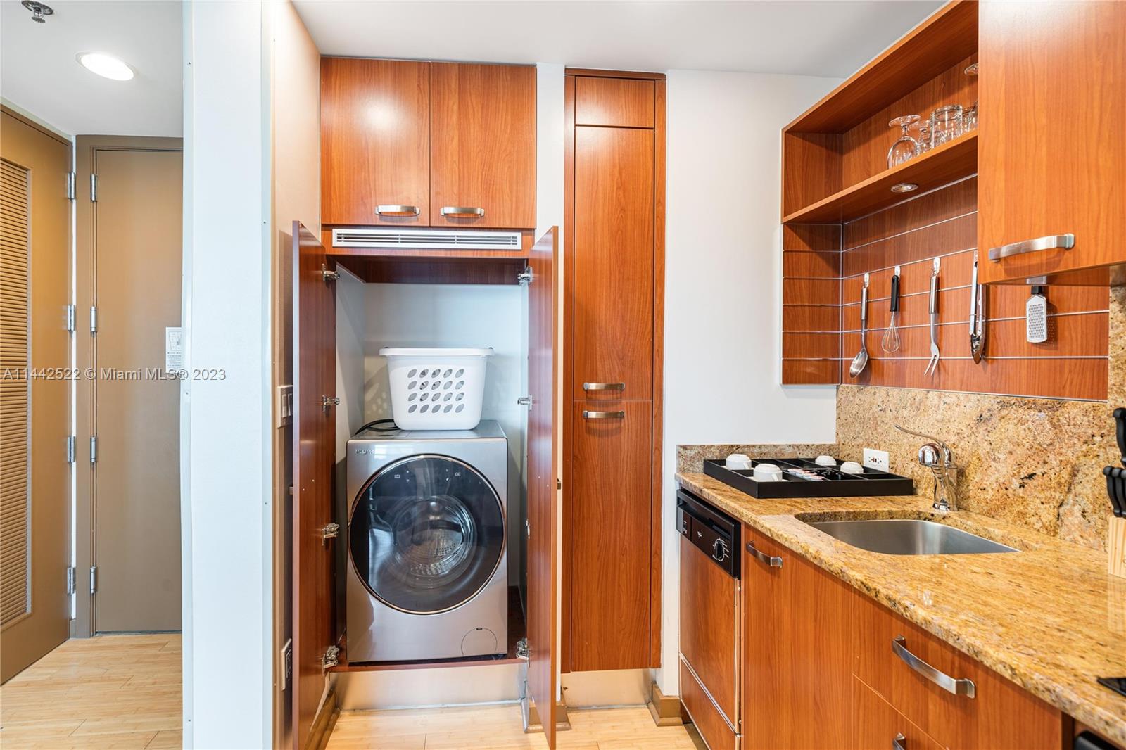 1395 Brickell Avenue, Unit 3205 Miami, FL 33131 - Photo 6 of 18 a kitchen with a sink and a refrigerator