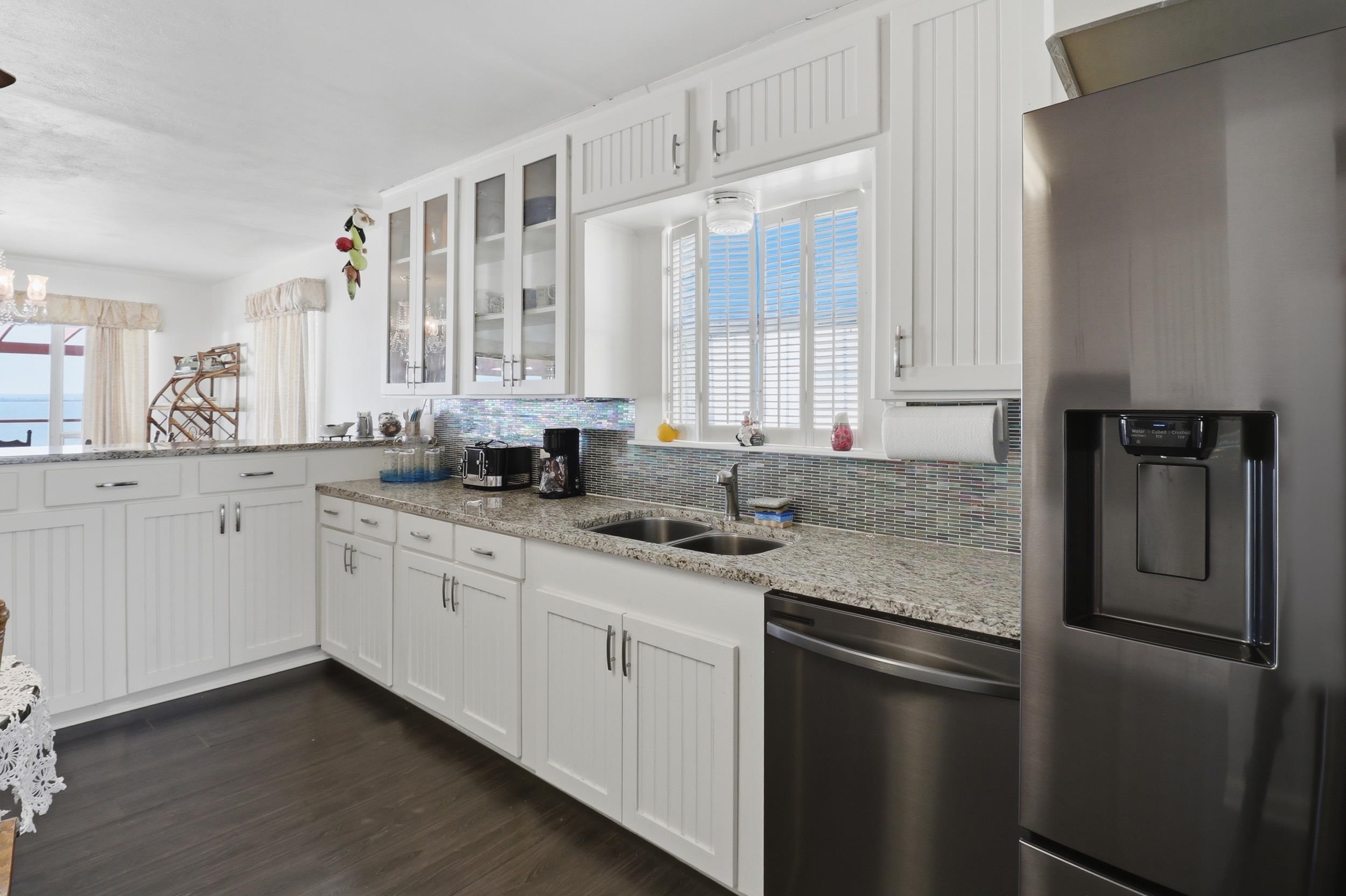 919 Lakeshore Loop Tow, TX 78672 - Photo 4 of 33 a kitchen with stainless steel appliances granite countertop a sink a refrigerator and white cabinets