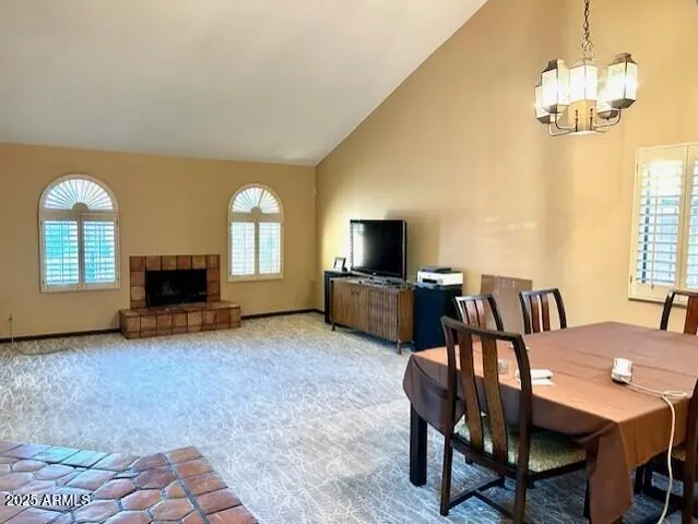 a view of a dining room with furniture and a chandelier
