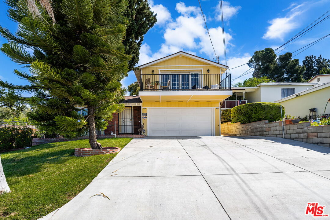11080 Plainview Avenue Tujunga, CA 91042 - Photo 1 of 41 a front view of a house with a yard