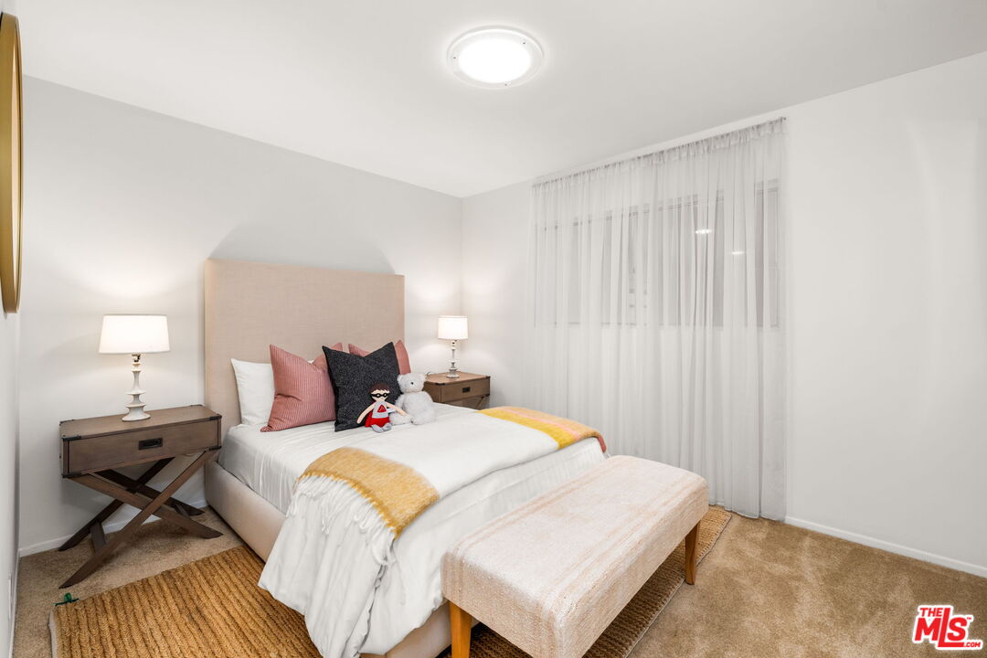 11080 Plainview Avenue Tujunga, CA 91042 - Photo 19 of 41 a bed room with a bed and a lamp