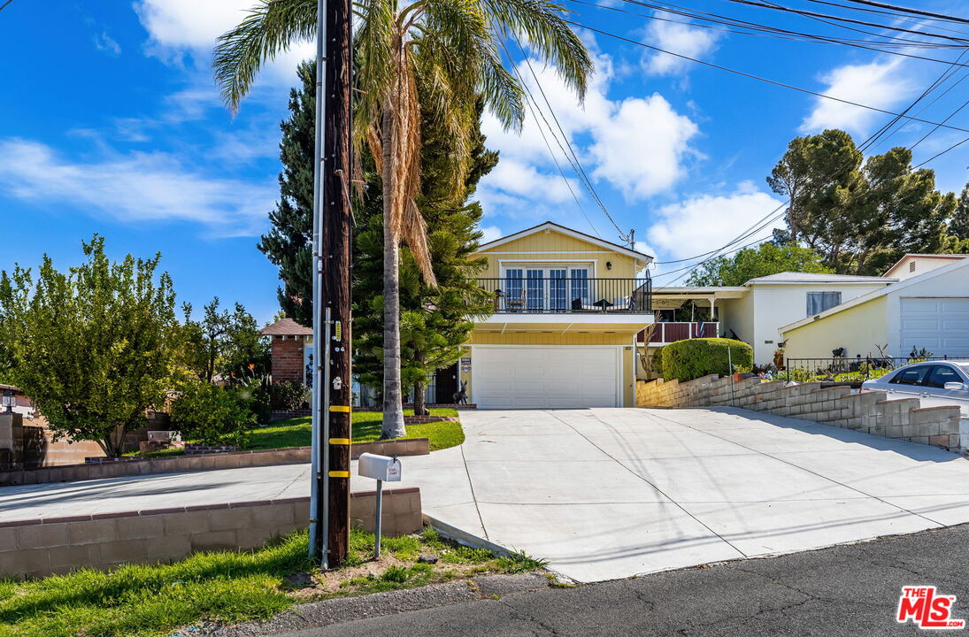 11080 Plainview Avenue Tujunga, CA 91042 - Photo 2 of 41 a front view of a house with a yard