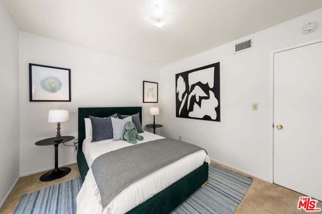 11080 Plainview Avenue Tujunga, CA 91042 - Photo 21 of 41 a bedroom with a bed and painting on the wall