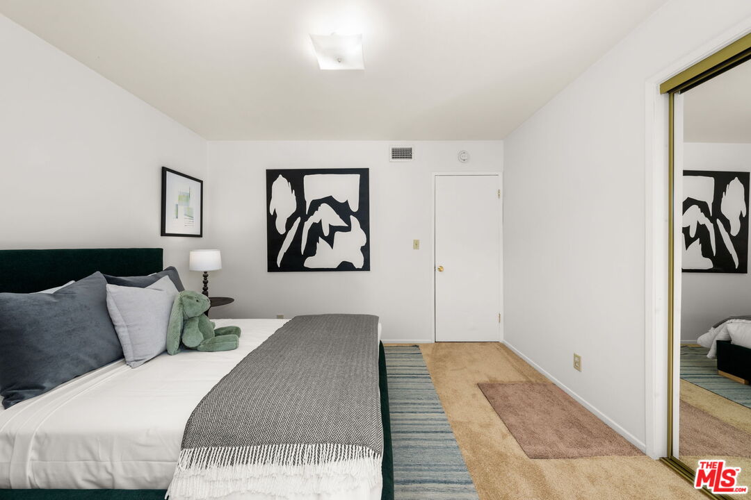 11080 Plainview Avenue Tujunga, CA 91042 - Photo 22 of 41 a bedroom with a bed and painting on the wall