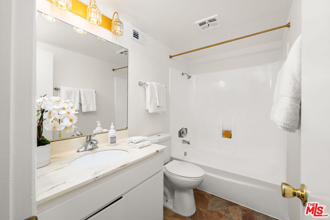 11080 Plainview Avenue Tujunga, CA 91042 - Photo 25 of 41 a bathroom with a granite countertop sink a toilet and shower