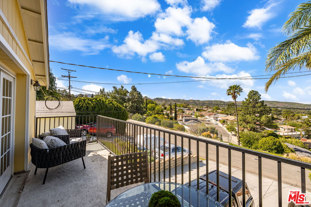 11080 Plainview Avenue Tujunga, CA 91042 - Photo 29 of 41 a view of a balcony with couches and wooden floor