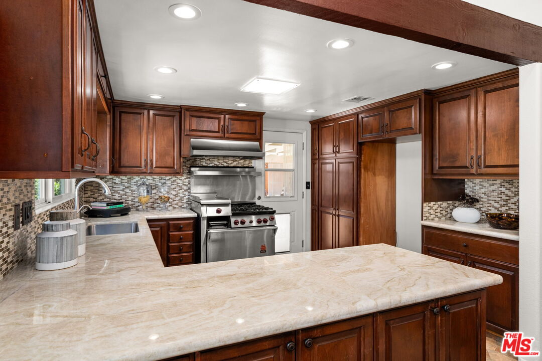 11080 Plainview Avenue Tujunga, CA 91042 - Photo 10 of 41 a kitchen with stainless steel appliances granite countertop a sink stove and refrigerator