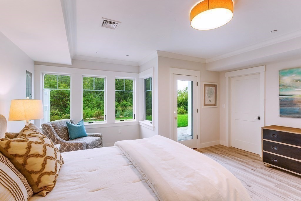 163 Atlantic Road, Unit 8 Gloucester, MA 01930 - Photo 16 of 21 a bedroom with a bed and a large window