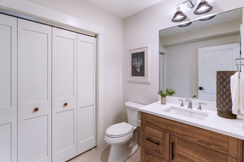 163 Atlantic Road, Unit 8 Gloucester, MA 01930 - Photo 17 of 21 a bathroom with a sink a toilet and vanity