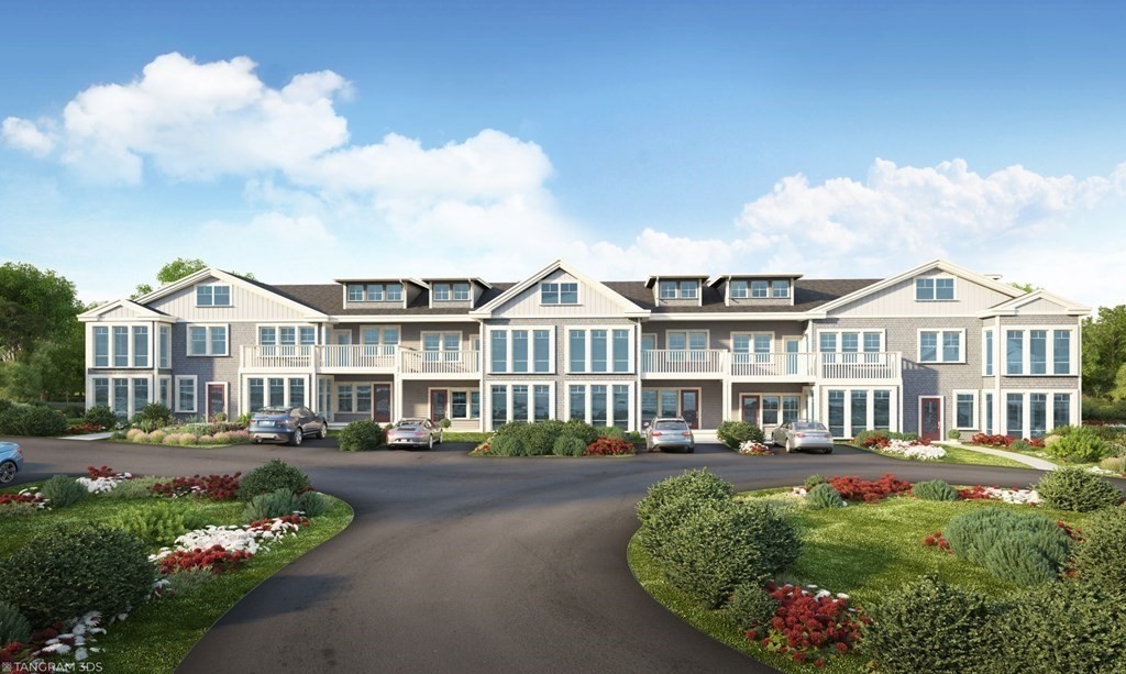 163 Atlantic Road, Unit 8 Gloucester, MA 01930 - Photo 2 of 21 a front view of a residential apartment building with a yard
