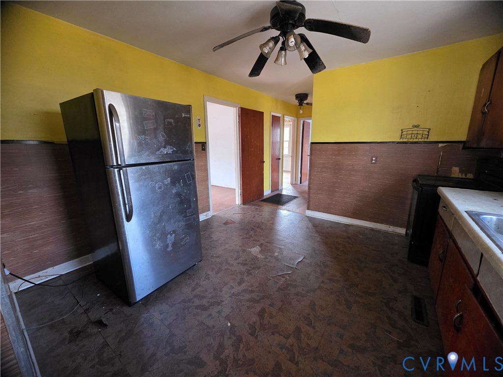 1429 Taro Road Cullen, VA 23934 - Photo 4 of 23 a view of a refrigerator in kitchen and an empty room