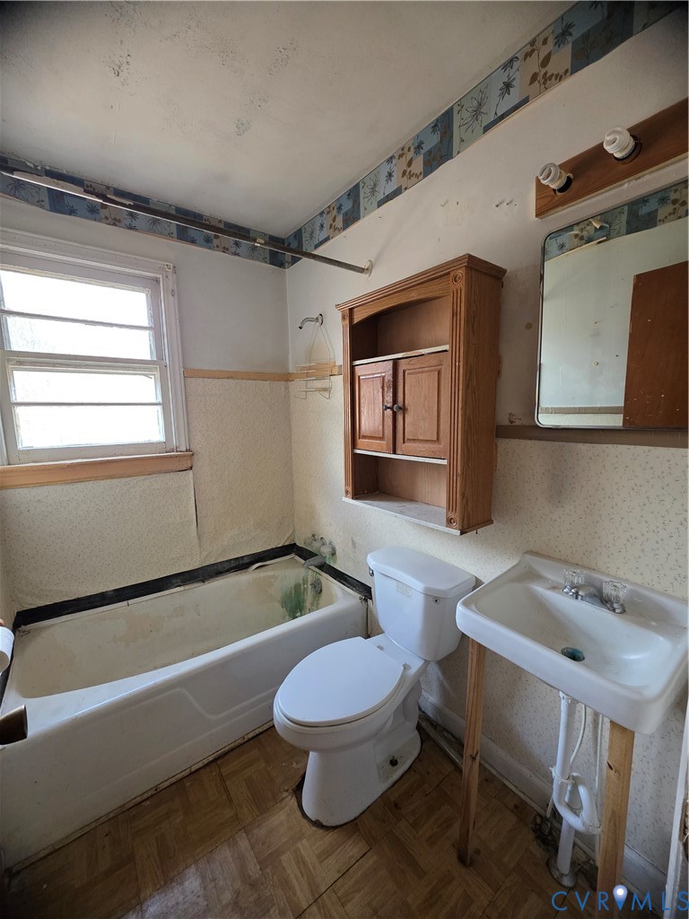 1429 Taro Road Cullen, VA 23934 - Photo 10 of 23 a bathroom with a sink a toilet a mirror and bathtub