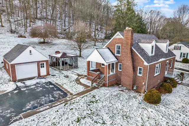 a view of a house with a yard and sitting area