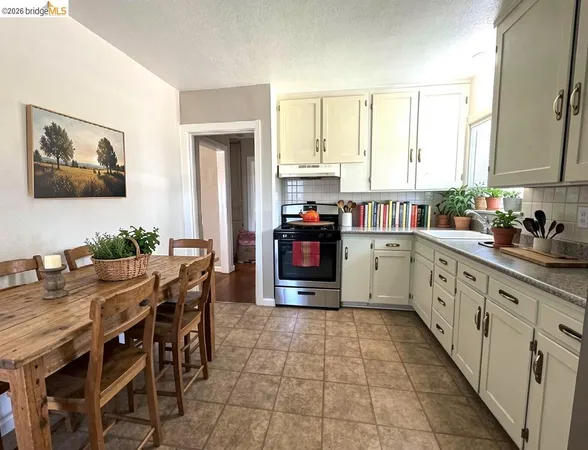 a kitchen with stainless steel appliances a stove top oven and a refrigerator