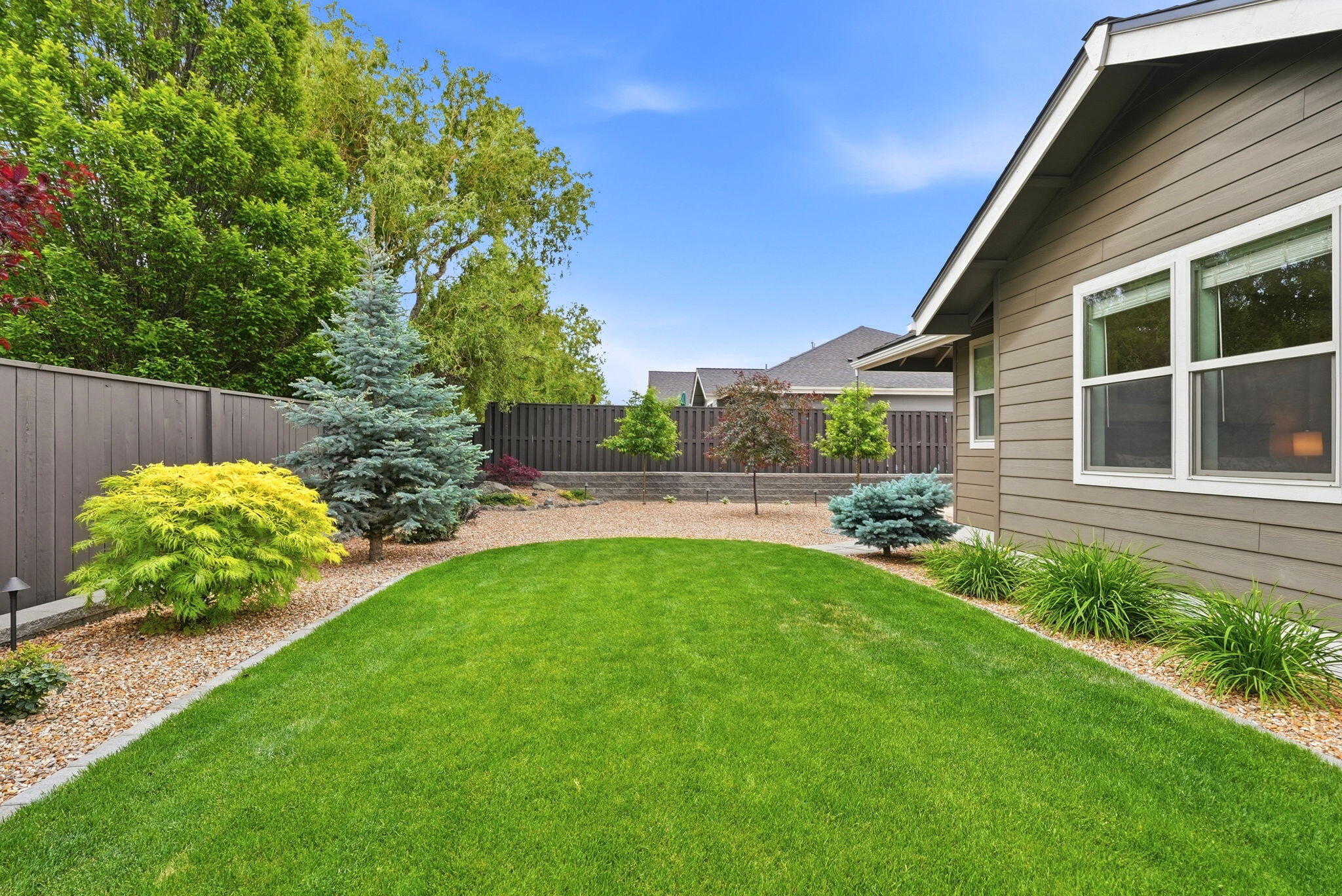 2714 Northwest 23rd Street Redmond, OR 97756 - Photo 51 of 57 a view of a backyard with plants and a patio