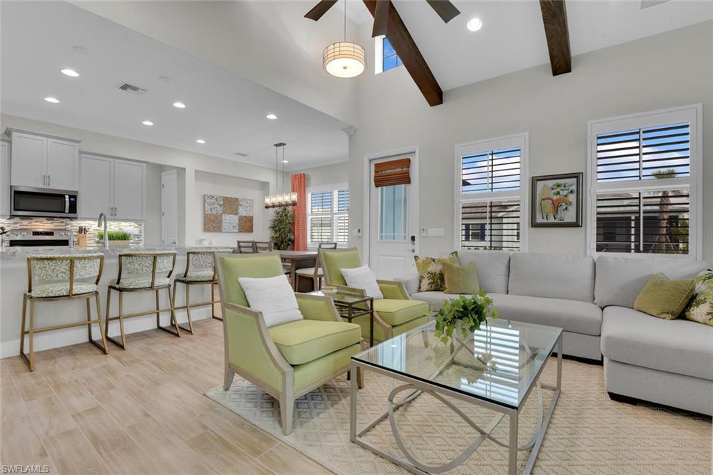 7110 Cayo Coco Lane Naples, FL 34113 - Photo 13 of 45 a living room with furniture and a flat screen tv