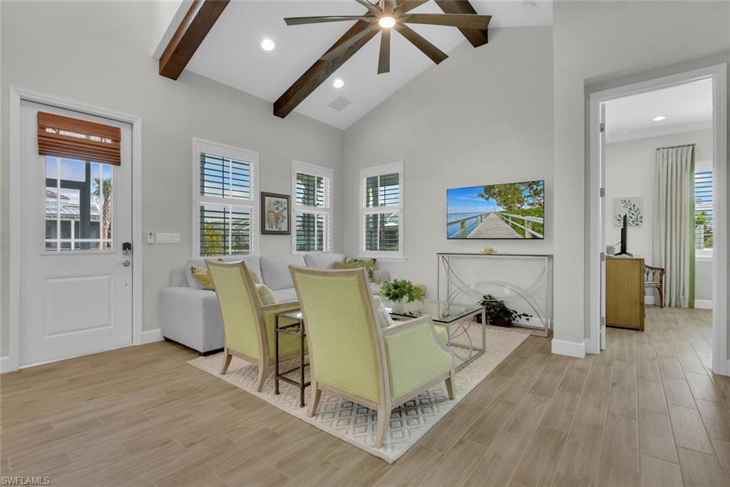 7110 Cayo Coco Lane Naples, FL 34113 - Photo 16 of 45 a living room with furniture and a wooden floor