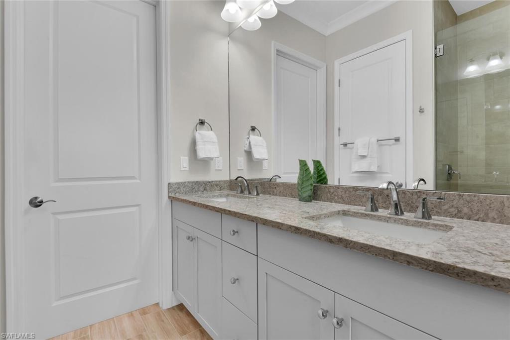 7110 Cayo Coco Lane Naples, FL 34113 - Photo 20 of 45 a bathroom with a granite countertop sink and a mirror