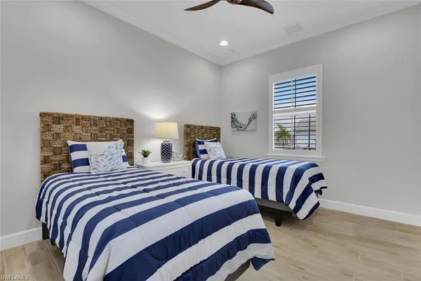a bedroom with two beds and a window
