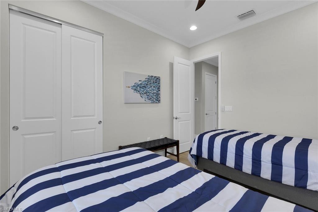 7110 Cayo Coco Lane Naples, FL 34113 - Photo 23 of 45 a bedroom with a bed and painting on the wall