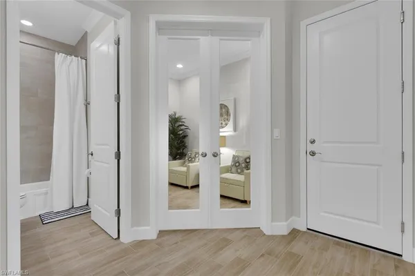 a view of a hallway with wooden floor windows and livingroom