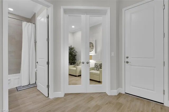 a view of a hallway with wooden floor windows and livingroom