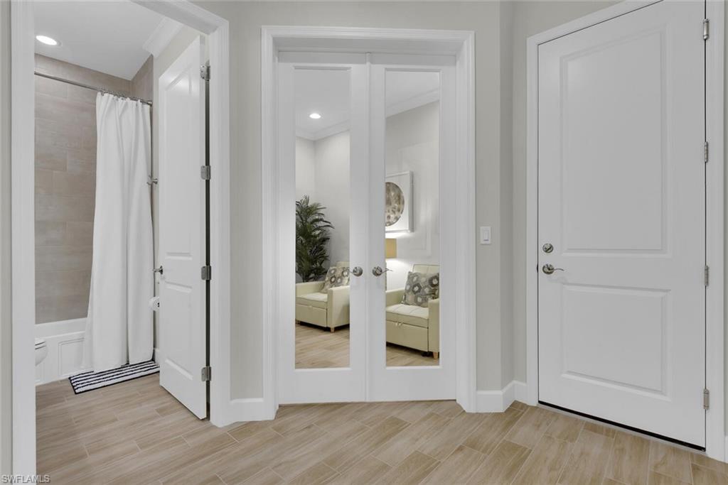 7110 Cayo Coco Lane Naples, FL 34113 - Photo 25 of 45 a view of a hallway with wooden floor windows and livingroom