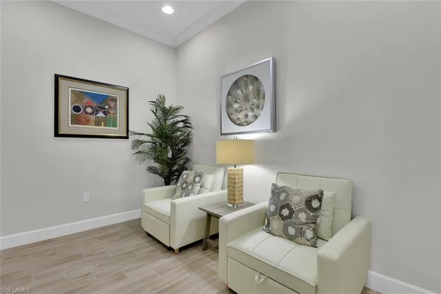 a living room with furniture and a wall painting