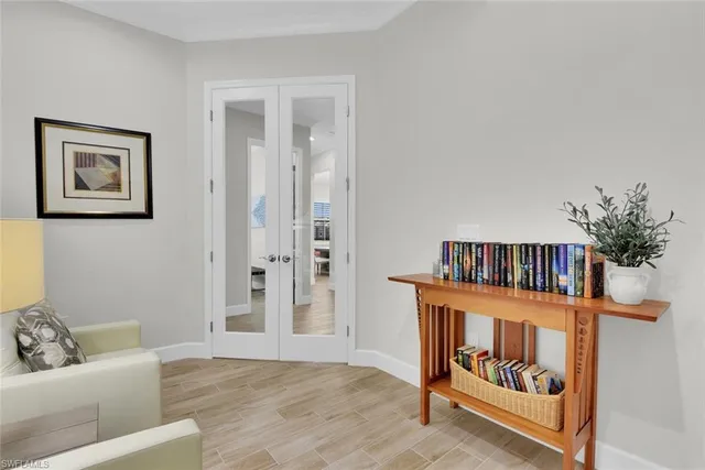 a living room with furniture and baby crib