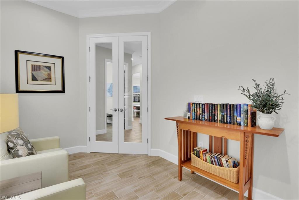 7110 Cayo Coco Lane Naples, FL 34113 - Photo 27 of 45 a living room with furniture and baby crib