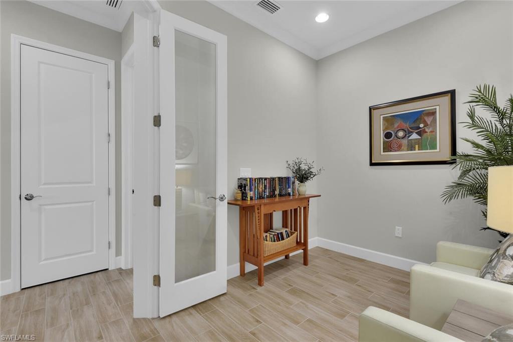 7110 Cayo Coco Lane Naples, FL 34113 - Photo 28 of 45 a living room with furniture and wooden floor
