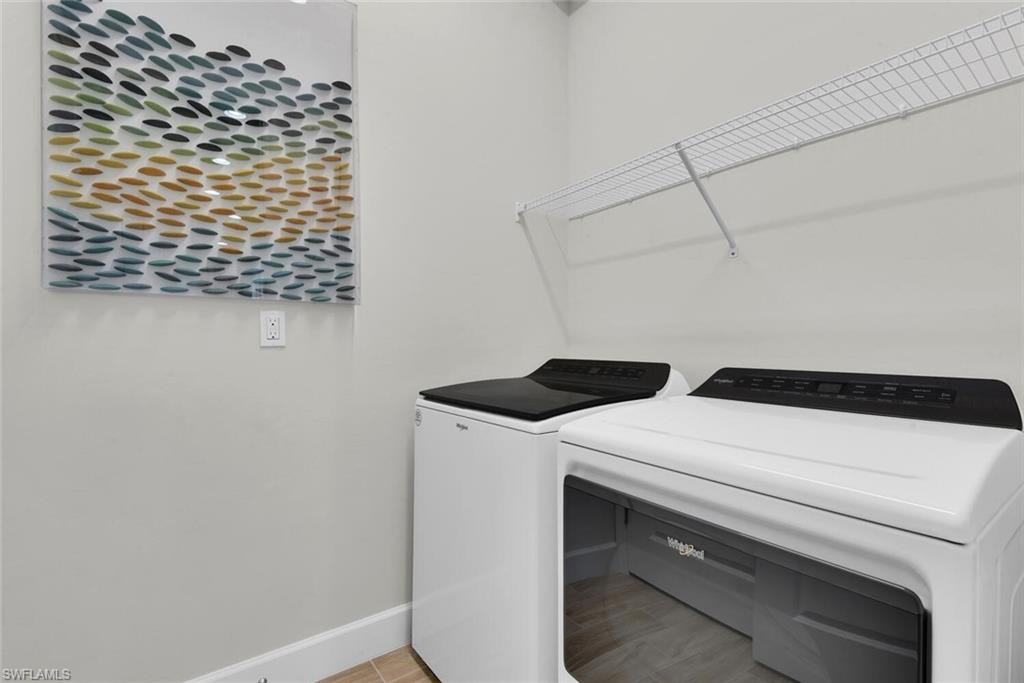 7110 Cayo Coco Lane Naples, FL 34113 - Photo 29 of 45 a utility room with dryer and washer