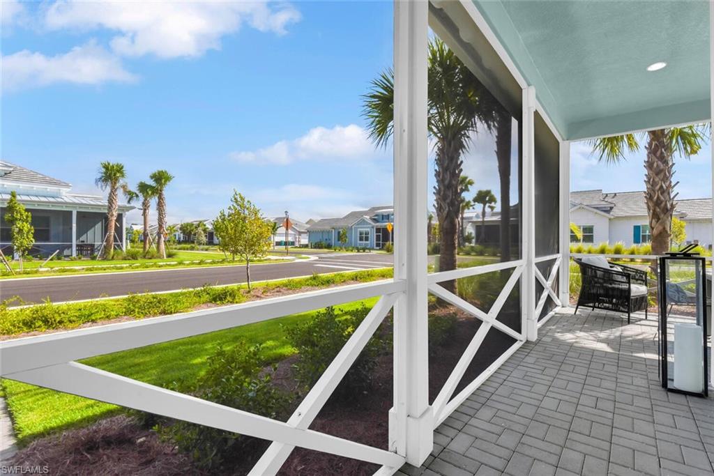 7110 Cayo Coco Lane Naples, FL 34113 - Photo 30 of 45 a view of a swimming pool with a lawn chairs and a large tree