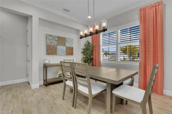 a view of a dining room with furniture window and wooden floor