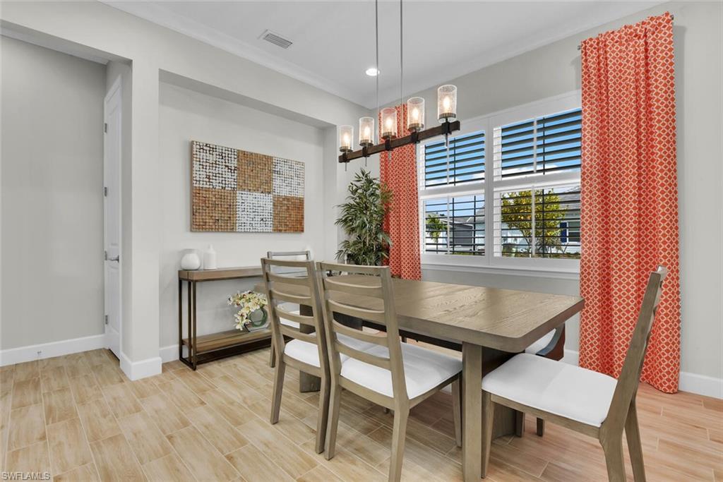 7110 Cayo Coco Lane Naples, FL 34113 - Photo 7 of 45 a dining room with furniture and window