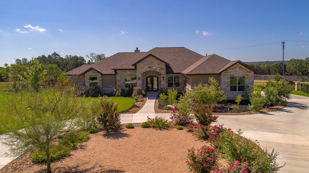 a front view of a house with a garden