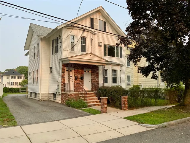 a front view of a house with a yard