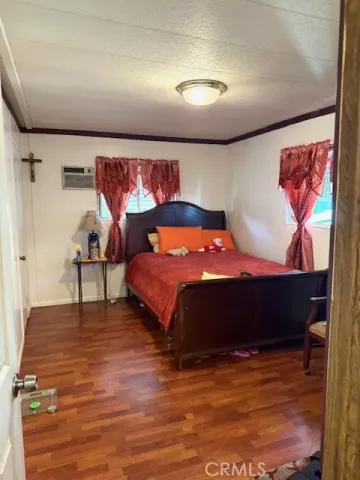 a bedroom with furniture and wooden floor