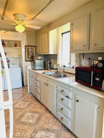 a kitchen with cabinets and window