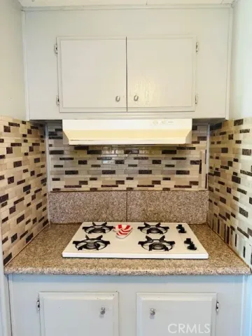 a kitchen with a stove and cabinets