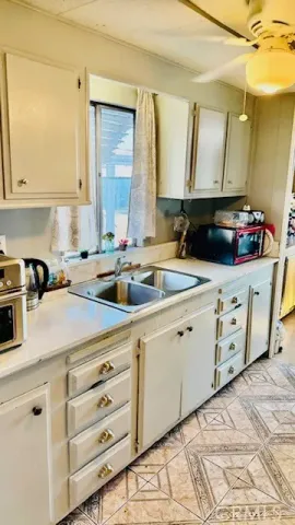 a kitchen with cabinets appliances a sink and a counter top space