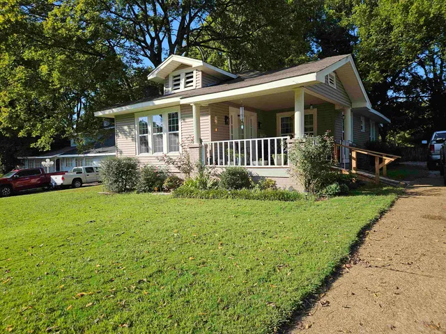 a front view of house with yard and green space