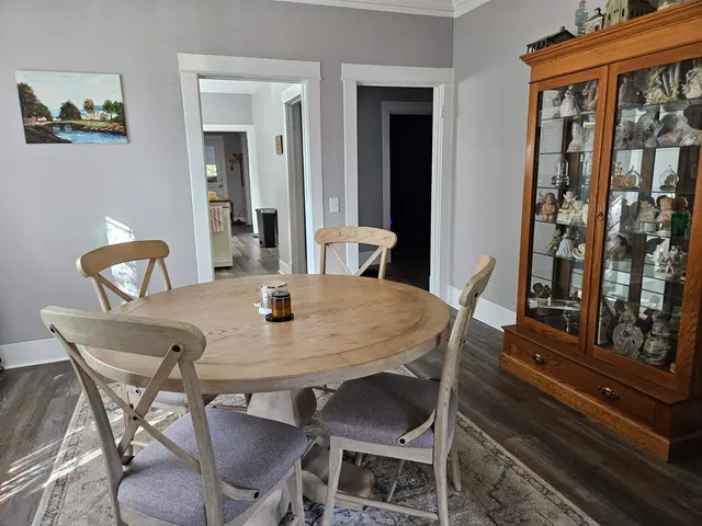a view of a dining room with furniture and wooden floor
