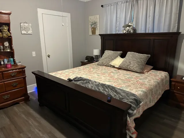 a bed sitting in a bedroom next to a cabinet