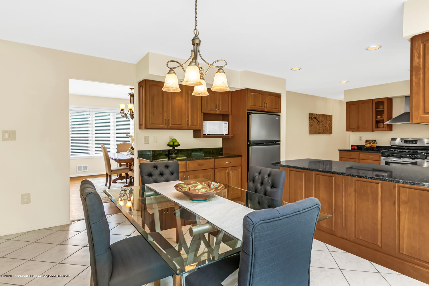 38 Knob Hill Road Morganville, NJ 07751 - Photo 11 of 35 a dining room with furniture a chandelier and wooden floor