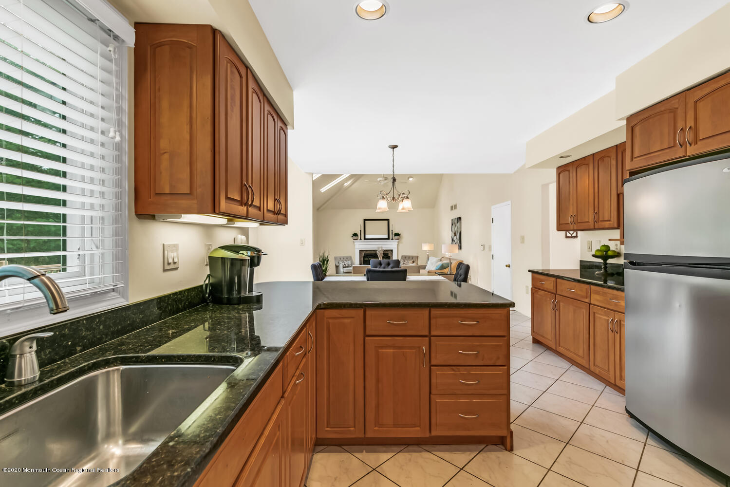 38 Knob Hill Road Morganville, NJ 07751 - Photo 34 of 35 a kitchen with granite countertop a sink stainless steel appliances a counter top space and cabinets