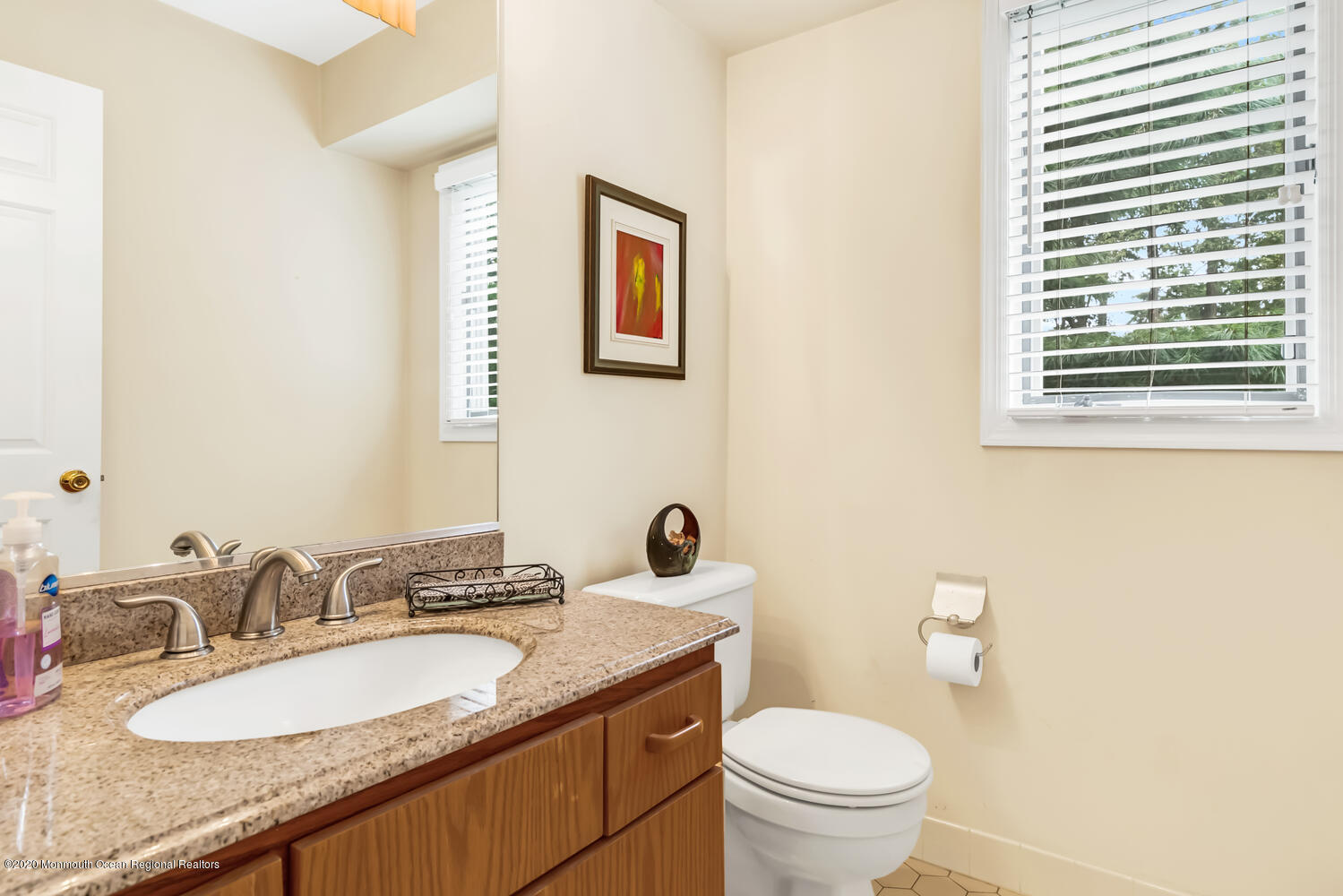 38 Knob Hill Road Morganville, NJ 07751 - Photo 17 of 35 a bathroom with a granite countertop toilet a sink and a mirror