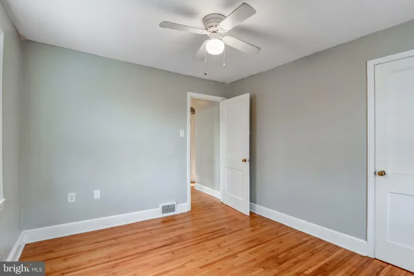 a view of an empty room and wooden floor