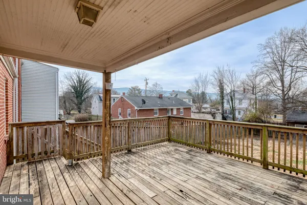 a view of a balcony with wooden floor